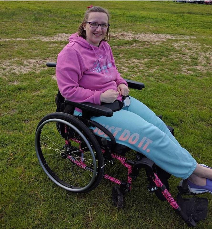 woman sitting in her wheelchair outside