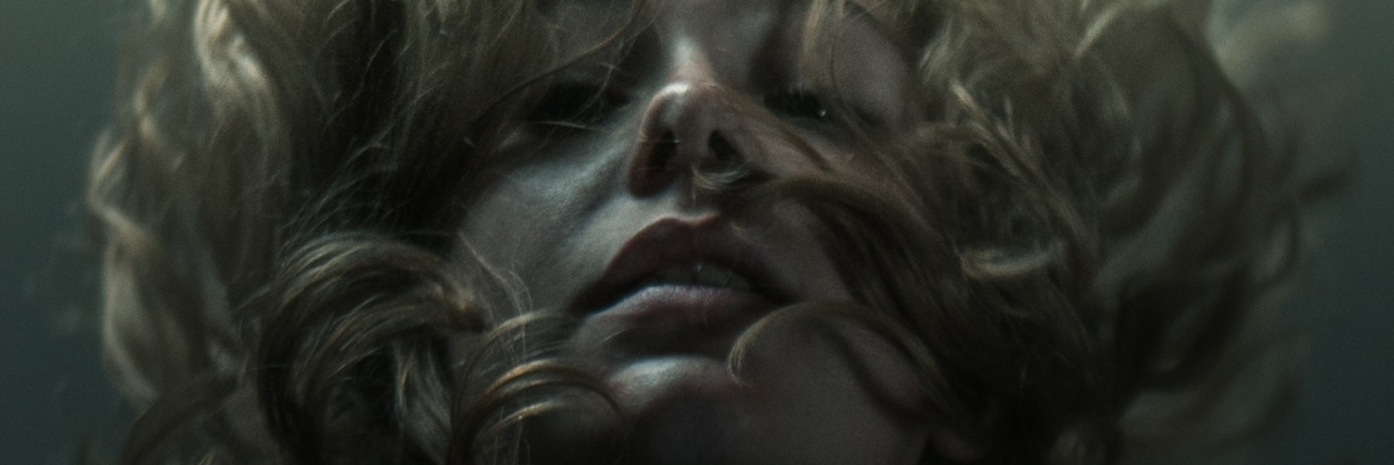 Metaphors for Suicidal Ideation to Show People Who Don't Understand woman underwater looking at camera 17 Metaphors for Suicidal Ideation to Show People Who Don't Understand