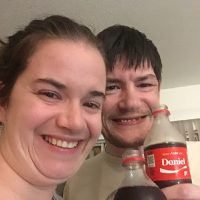 Daniel and Leah holding personalized Coke bottles.