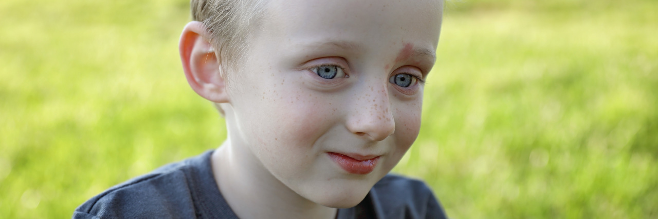 Close up image of boy, he is looking to the side