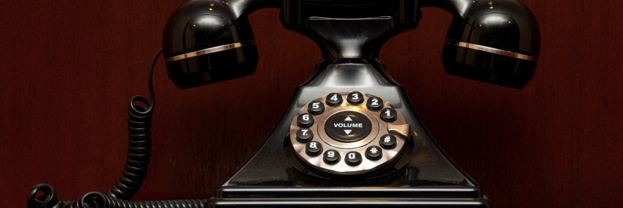 Dealing With Phone Calls as Someone Who Stutters Retro telephone on a wooden shelf.