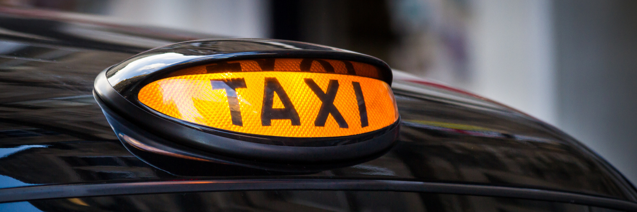 Hailing a Taxi as a Wheelchair User Taxi sign in U.K.