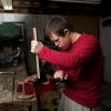 Teen with Down syndrome doing woodwork at a shop