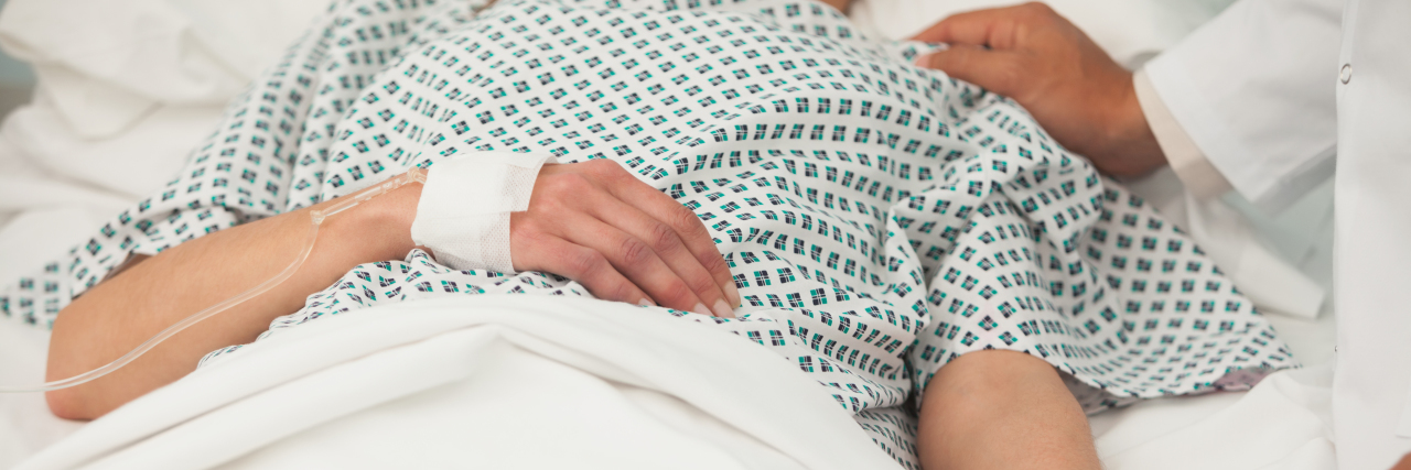 When the Hospital Staff Treated Me With Respect sick patient lying in hospital bed with a hand on her shoulder