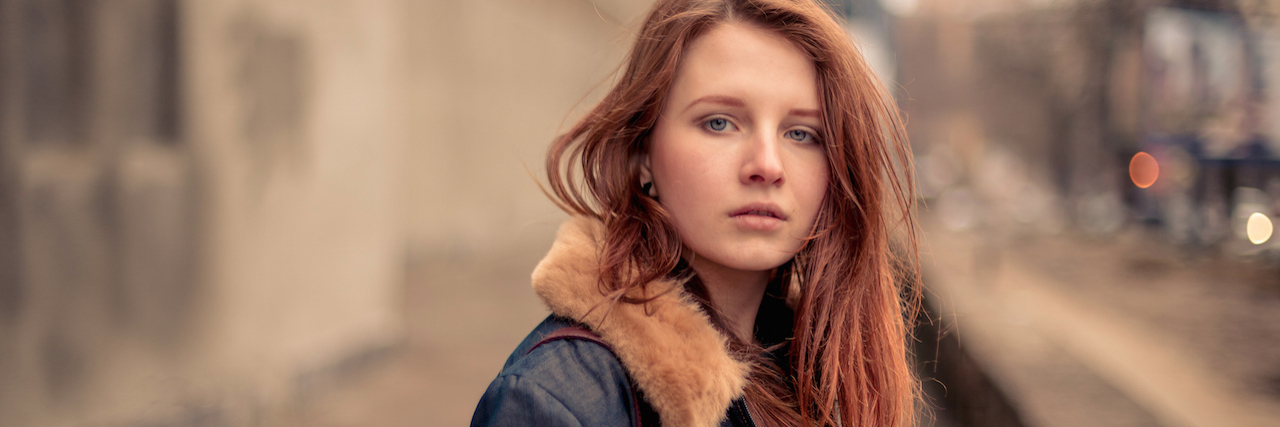 A Letter to My Mother About Self-Harm A woman on a city street