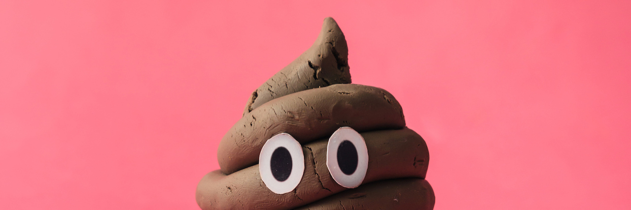 What It's Like to Live With 'Anxiety Poops' Poop emoticon on pink background.