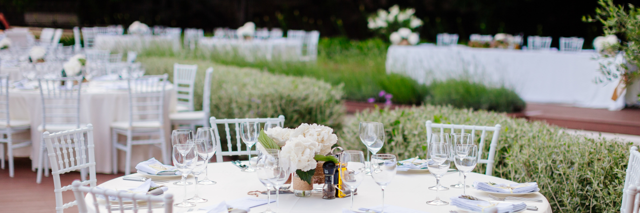 Tips for Summer Wedding Guests With Disabilities Table set for outdoor wedding reception.