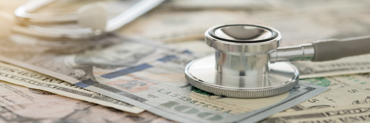 The Unexpected Cost of Having a Pre-Existing Condition stethoscope on dollar banknote money.