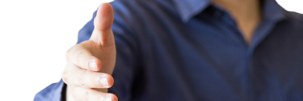 How Being Autistic Makes Me Sensitive to Touch Business person offering handshake.