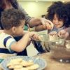 kids helping to stir food in a bowl