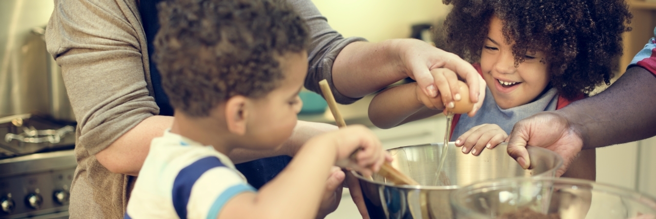 Parenting a Child With Nephrotic Syndrome and a Low-Salt Diet kids helping to stir food in a bowl