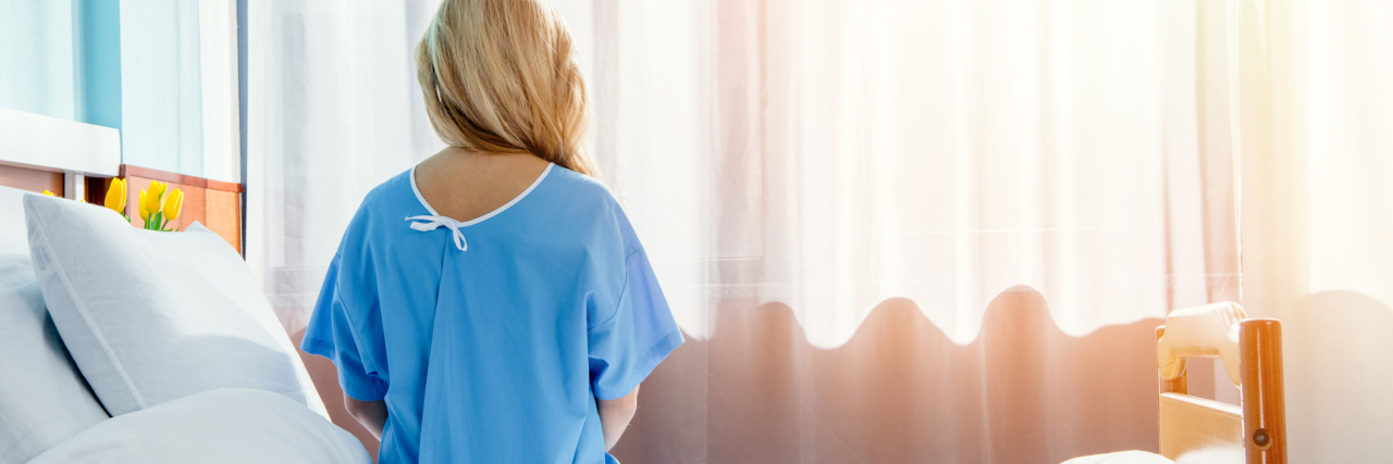 'Believe Women' Needs to Extend to Healthcare back view of woman sitting on bed in hospital chamber