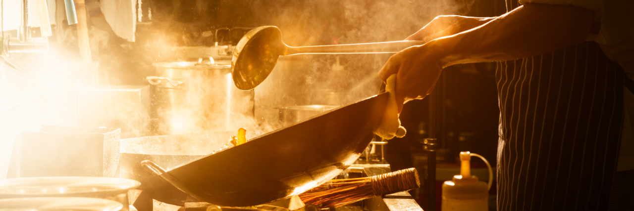 3 Steps You Can Take to Avoid Being 'Glutened' A chef cooking as steam rises from the pan.