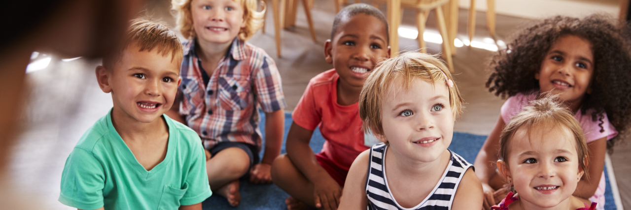 Why My Son's Class Deserves a Preschool Graduation Teacher At Montessori School Reading To Children At Story Time