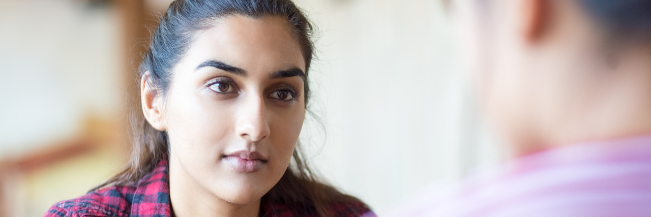 How to Be Heard When No One Wants to Hear About Your Pain Concentrated woman talking to friend. Serious young student looking at companion. They discussing strategy. Communication concept