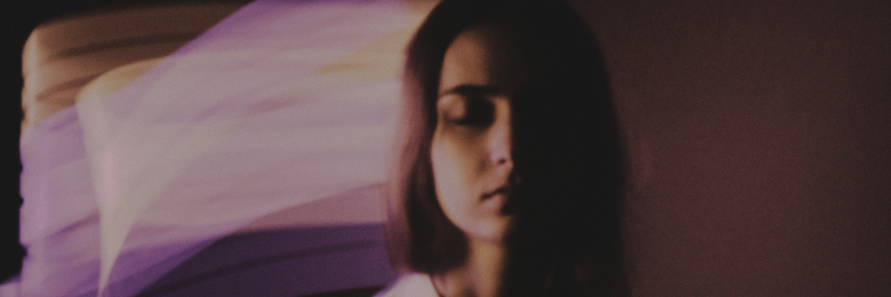 The Frustration of Fibro Fog woman with eyes closed and purple graphic design behind head