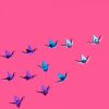 Origami birds on pink