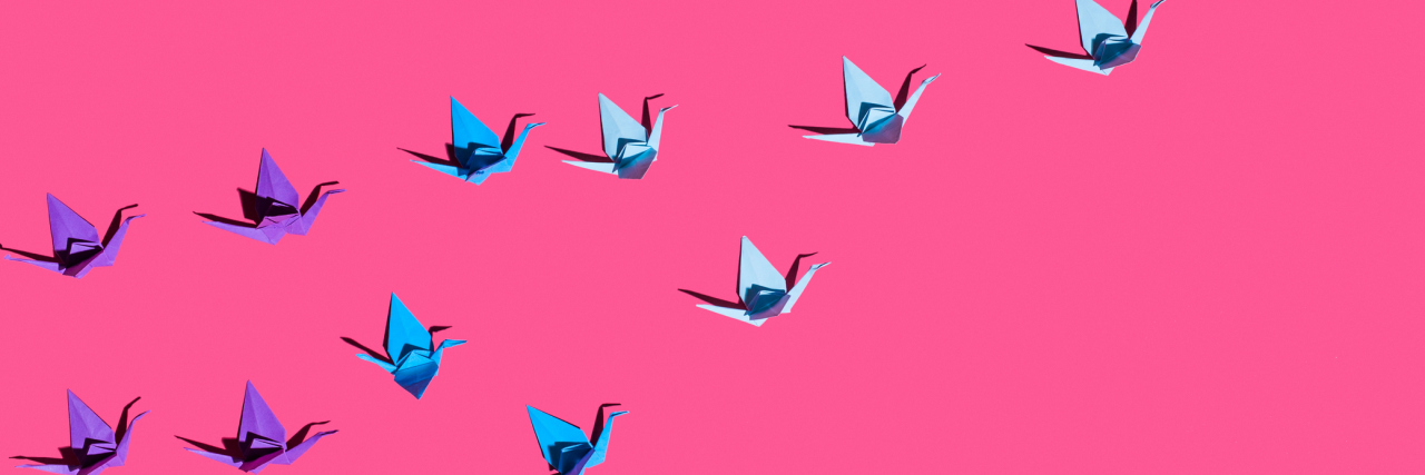 Origami birds on pink