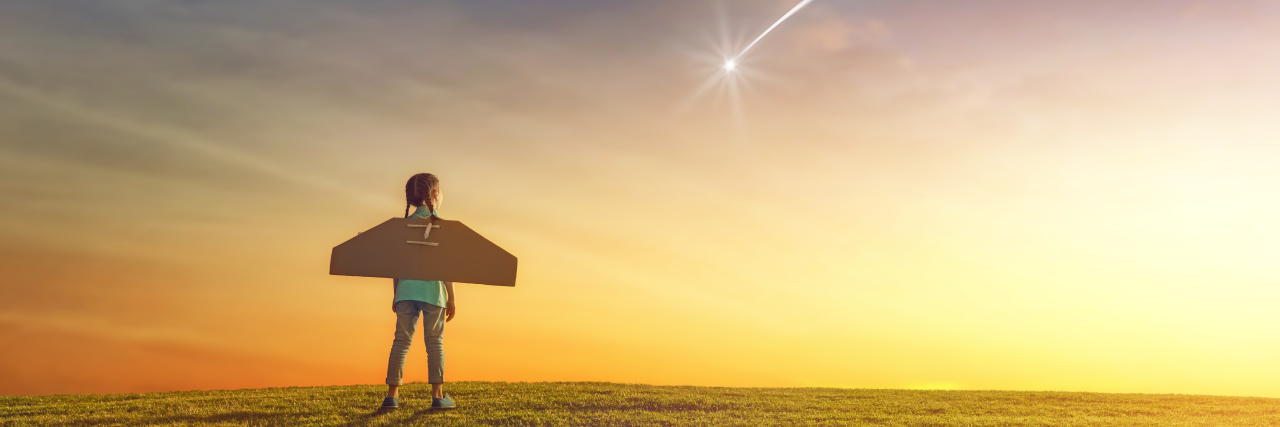 Holding Onto Dreams With a Chronic Illness Girl wearing paper wings looking towards a shooting star.