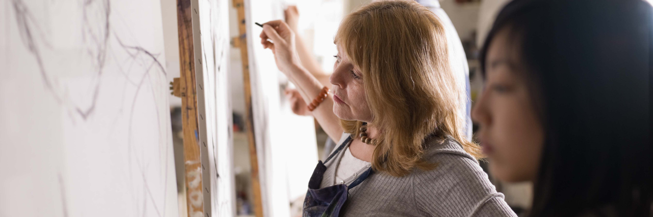 How Art Therapy Is Helping Me as I Live With Chronic Pain People painting on canvases.