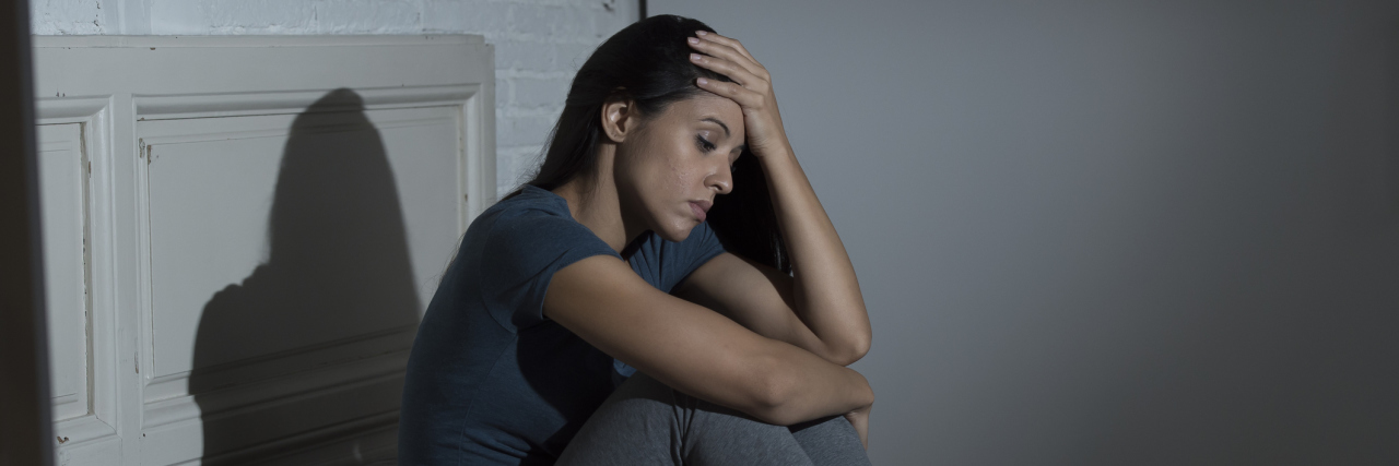 Why Saying 'I Believe in You' Can Be Hurtful With Chronic Illness woman sitting in bed looking tired