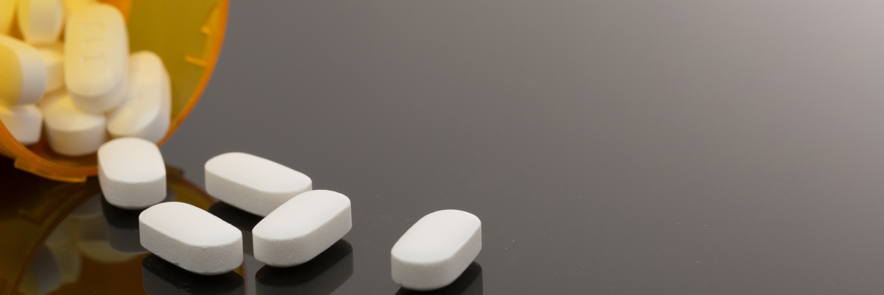 Embarrassment About Taking Epilepsy Medication Pills spilled out on table.