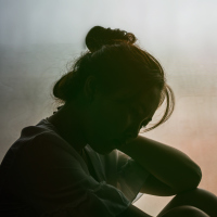 Silhouette of depressed woman.
