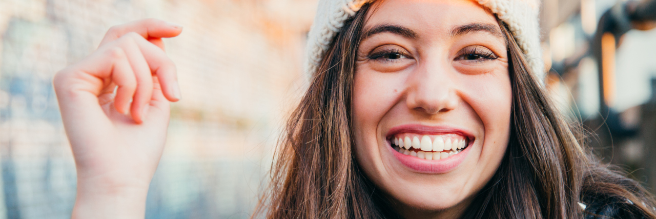 I'm Raising Awareness for ME With My Art, Heart and a Sense of Humor A picture of a woman outside, smiling.