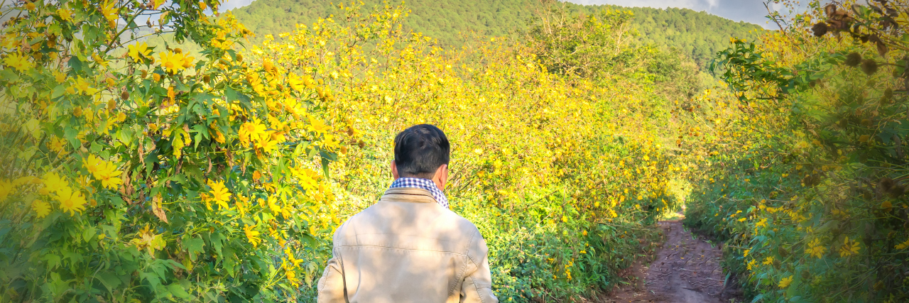 Benefits of Walking in the Countryside to Reduce Autism Stress Man walking alone on a rural road.