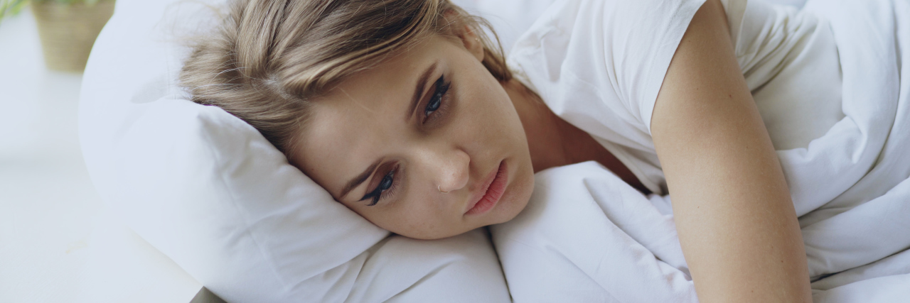 Eating Disorder Recovery Makes Me Tired Depressed young woman lying in bed and feeeling upset after quarrel with her boylfriend in bedroom at home