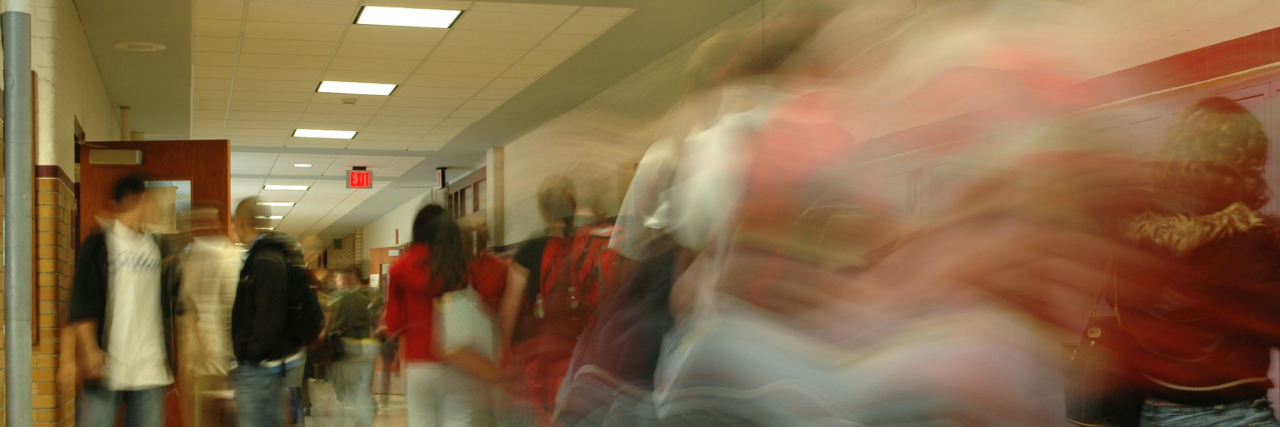 Blurry image of high school hallway