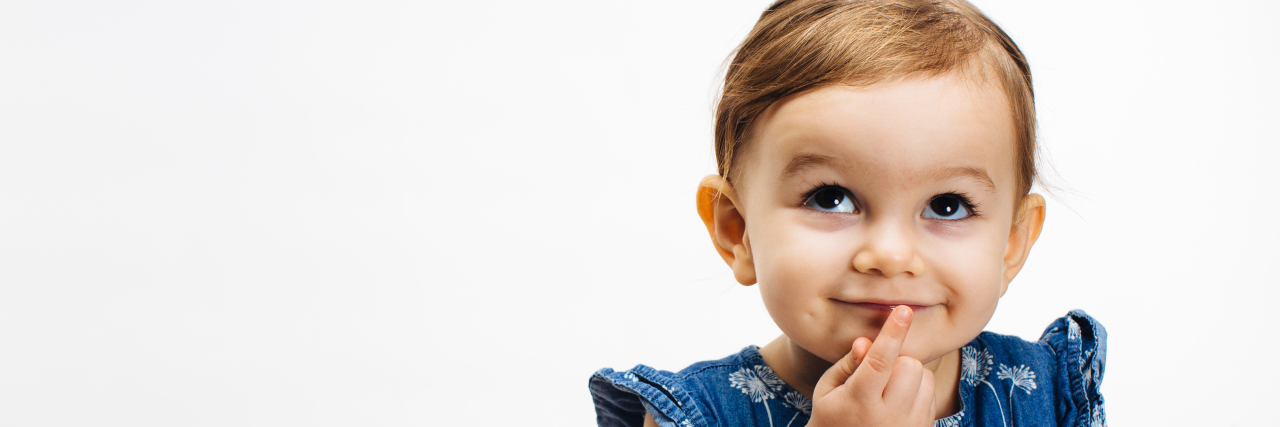 Teaching Children About People in Wheelchairs Small child with finger on mouth looking up,