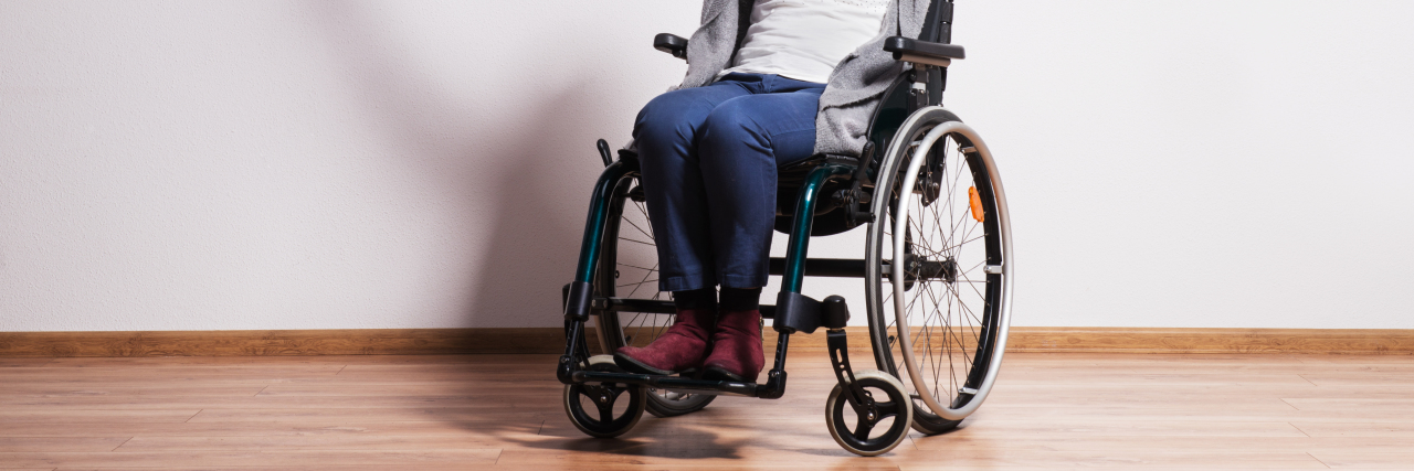 Ableism From Family Surrounding Wheelchair Use Woman in wheelchair.