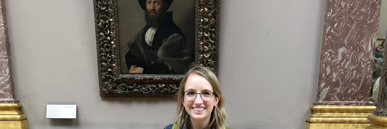 Visiting the Louvre Museum With Vision Loss Shannon Reyenga stands in front of the Portrait of Baldassare Castiglione.
