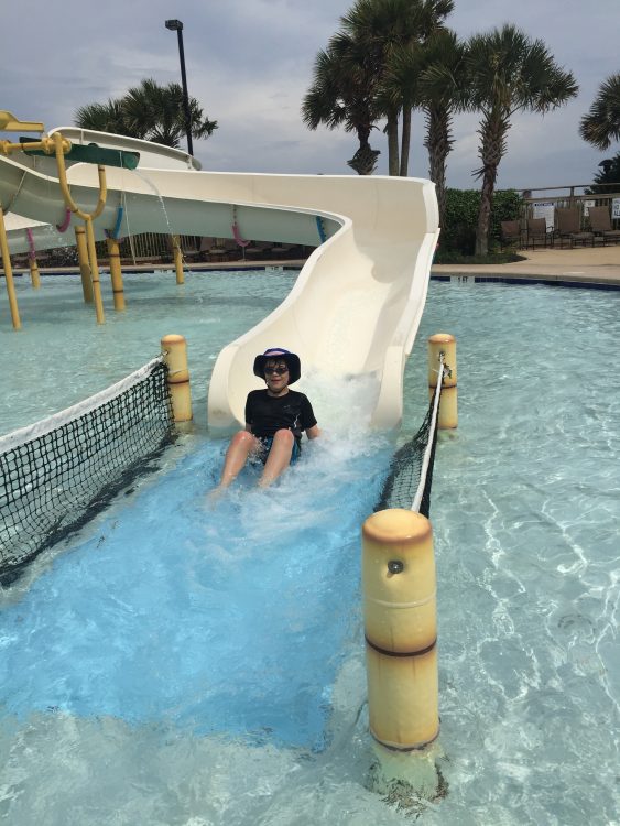 the author's son going down a waterslide 