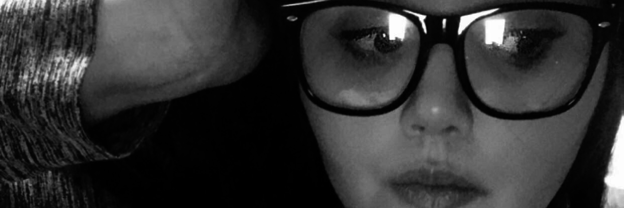 When Chronic Illness Makes You Feel Unworthy A photo o the writer looking away from the camera, looking deep in thought.