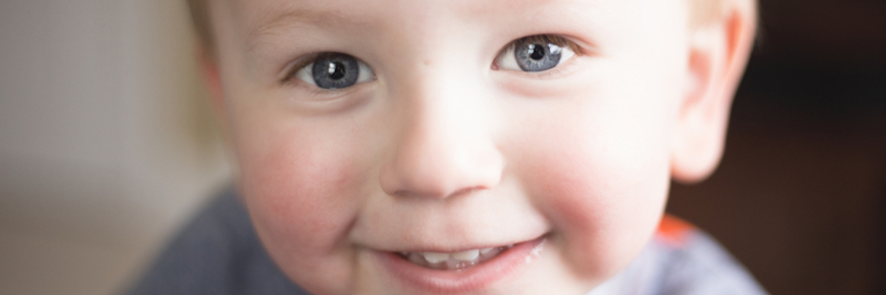 Close up of little boy smiling at camera