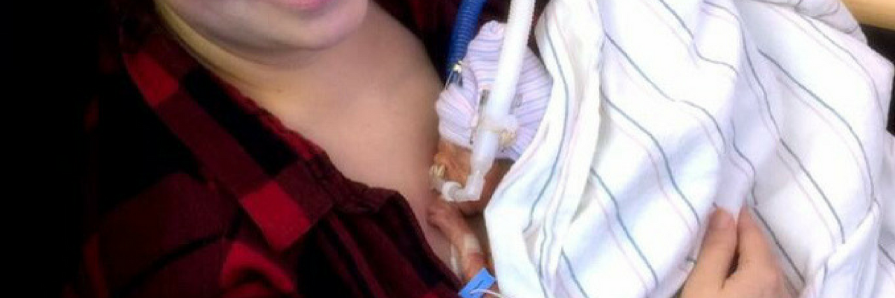 Postpartum Anxiety After a Traumatic Birth Experience Mother holding preemie baby at hospital. Baby is so small laying on mom's chest