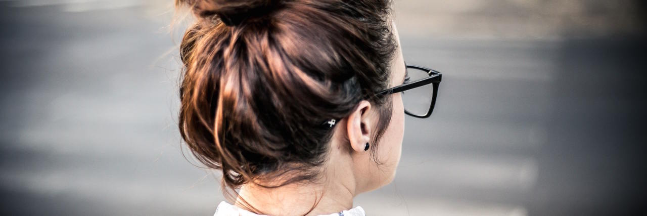 The 'Sign' That Lets Me Know I Am Sliding Back Into Depression woman messy bun