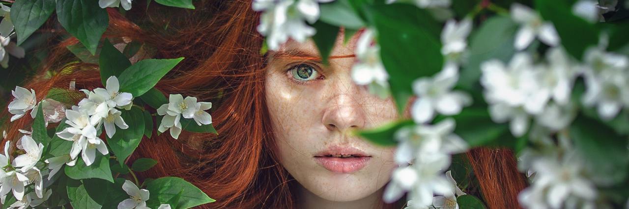 When You Realize You Don't Have 'High-Functioning' Depression Anymore woman hiding in flower bush