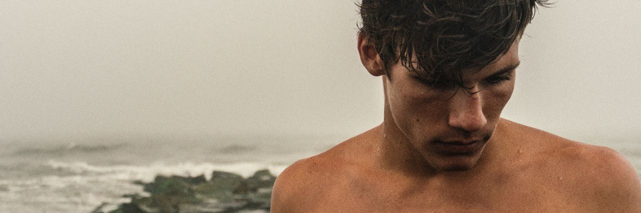 How I Manage My Borderline Personality Disorder man at seaside topless looking down cloudy weather