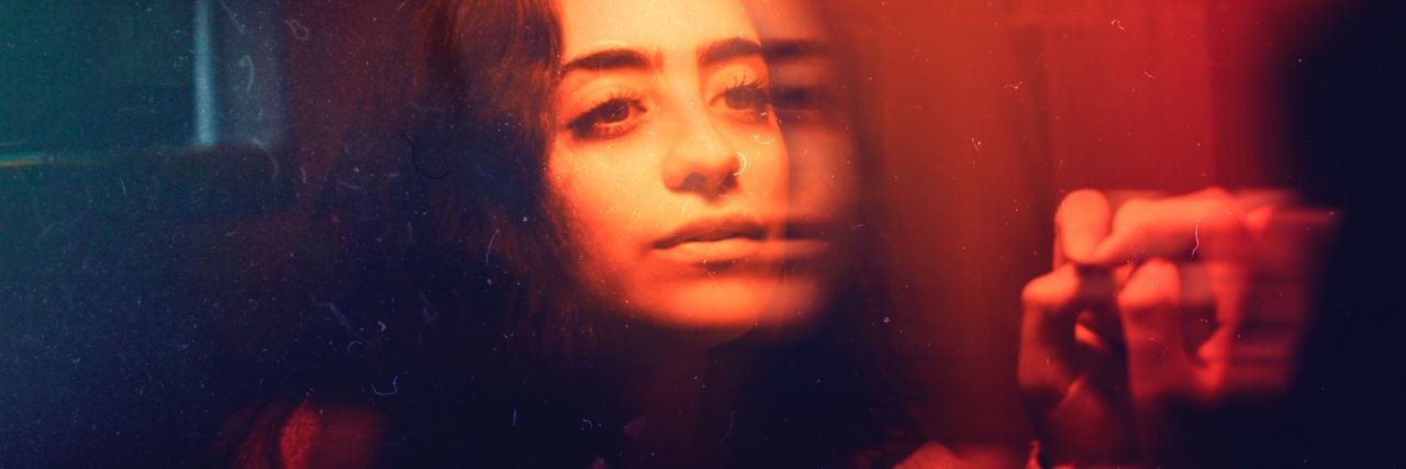Why Telling Me to 'Reach Out' When I'm Suicidal Doesn't Help blurry girl in mirror