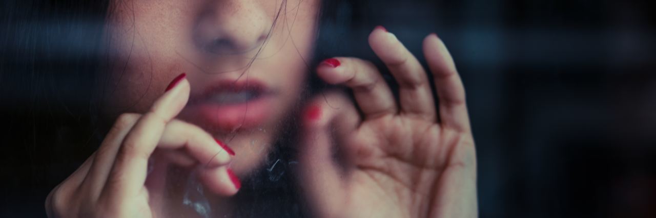 The Unique Way I Cope With My Anxiety young woman with hands close to mouth breathing eyes closed