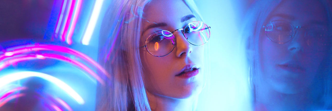 4 Unconventional Strategies for Coping With Anxiety woman with neon lights behind ehr