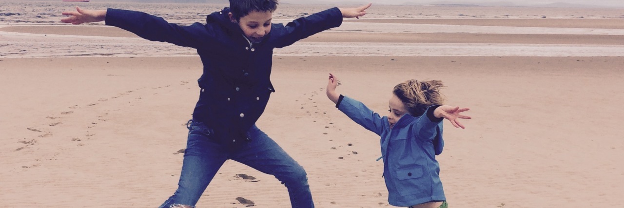 Balancing Work and Parenting With Asperger's Kay's children playing on the beach.