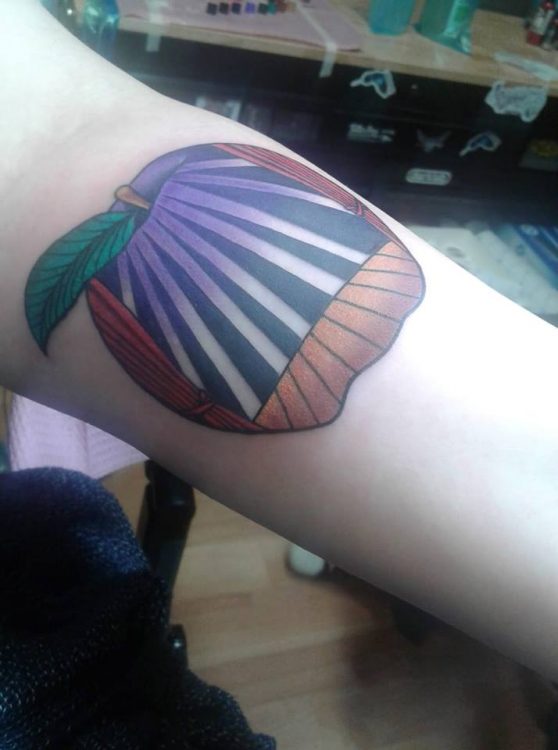 apple tattoo with musical theater stage