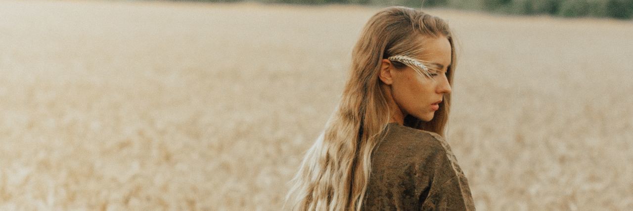 Growing Up With Bipolar Disorder and Childhood Emotional Abuse young blonde woman standing in wheat field