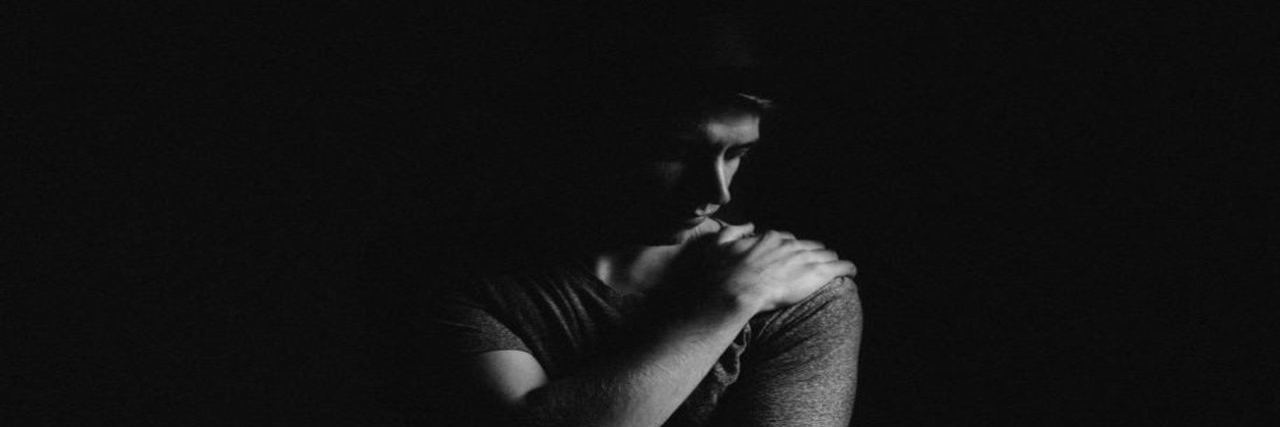 Toxic Shame and Chronic Illness Man looking down, struggling with feelings of shame.