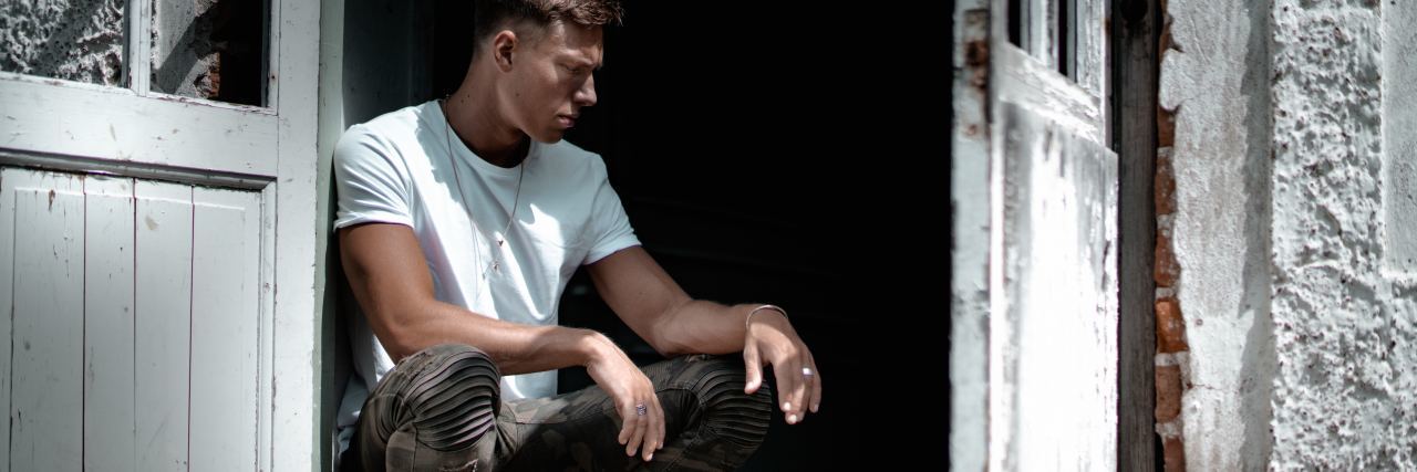 My Awful Experience With VA Vocational Rehab for Depression man kneeling in old doorway