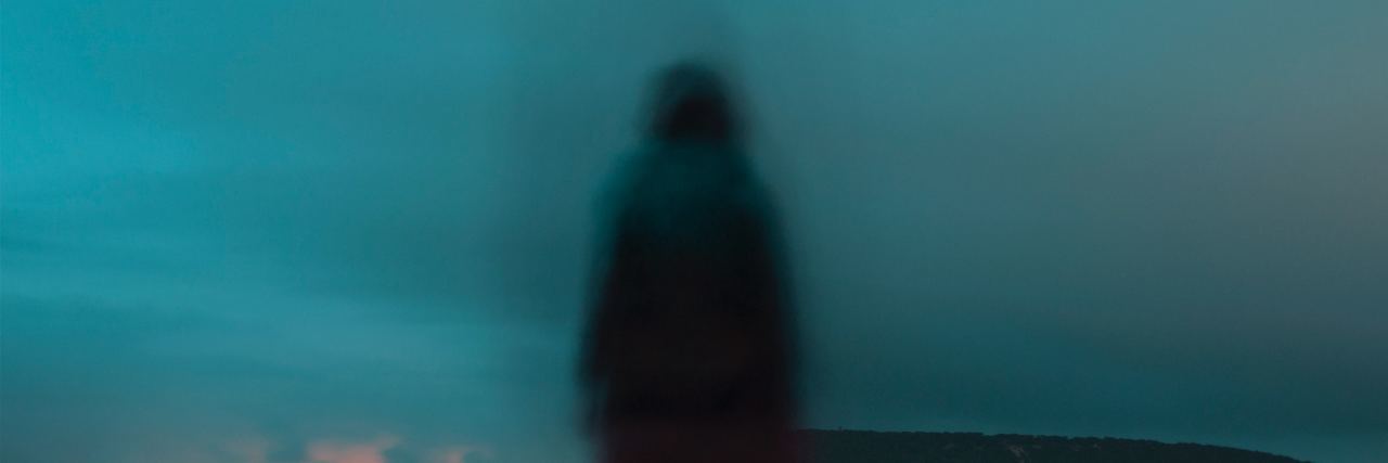 When Suicidal Thoughts Make You Feel Like You're 'Pretending' to Live blurred person standing in middle of road